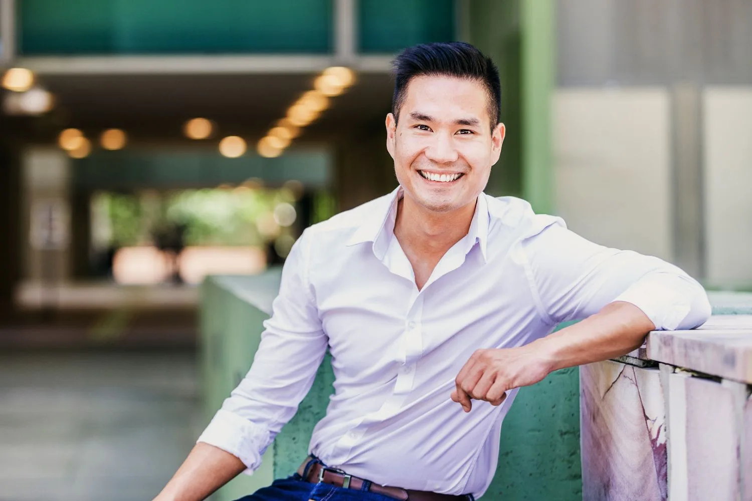 Relaxed outdoor corporate headshot of a businessman outside an office building