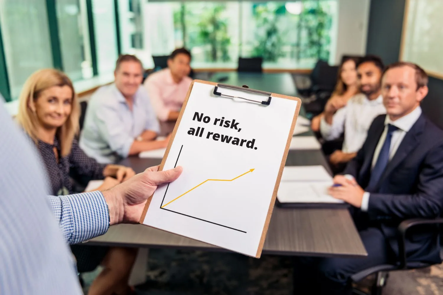Boardroom presentation holding a 'No risk, all reward' growth chart