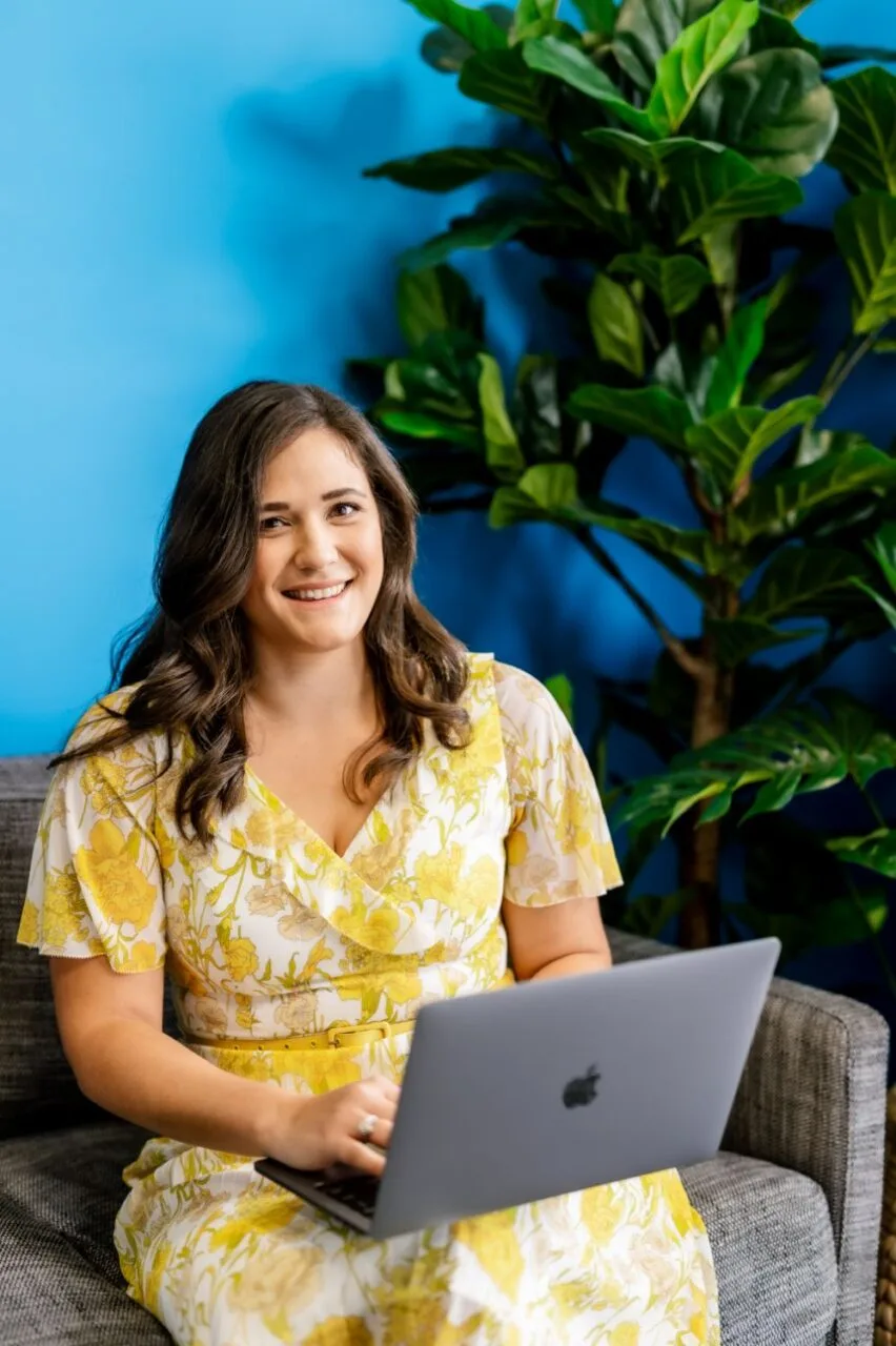 Lifestyle business portrait of a woman working on a laptop in a styled office